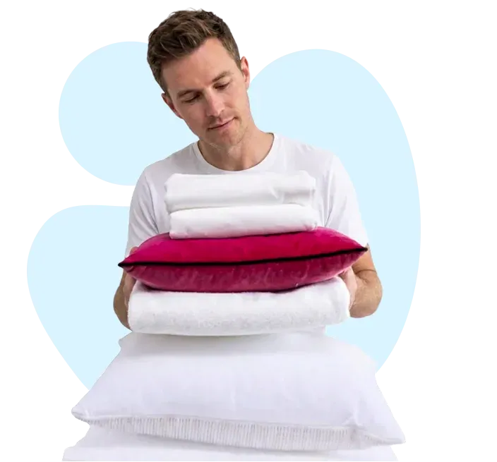 Stack of clean, fresh white towels and folded bed sheets in the UAE